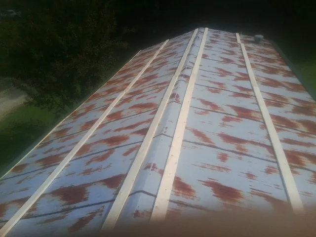 Rusted metal roof panels with new wood purlins before replacement — Storm Damage Roof Repair in Nucla by Roofing Brothers